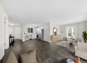 Thumbnail 11 of 22 - A living room with a couch, chairs, and a dining table at Amberly Apartments, West Bloomfield, 48322