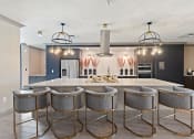 Thumbnail 14 of 19 - a large kitchen with a large island and a row of stools  at The Griffin Royal Oak, Royal Oak, 48067