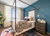 Thumbnail 10 of 19 - a bedroom with blue walls and a four poster bed  at The Griffin Royal Oak, Royal Oak, Michigan