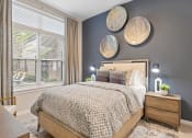Thumbnail 3 of 19 - a bedroom with gray walls and a bed with a wooden headboard  at The Griffin Royal Oak, Royal Oak, 48067