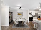 Thumbnail 12 of 34 - a dining room with a table and chairs and a kitchen at Cidermill Village, 48307