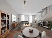 Thumbnail 5 of 17 - A modern living room with a grey sofa, a round table, and a wooden cabinet.