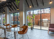 Thumbnail 6 of 25 - A room with a table and chairs and a fireplace.
