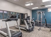 Thumbnail 5 of 25 - A gym with treadmills and other exercise equipment.