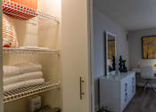 Thumbnail 21 of 25 - A bathroom with a white chair and a white cabinet.