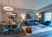 Thumbnail 3 of 53 - A modern living room with a dining table and chairs.