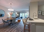 Thumbnail 4 of 53 - A modern kitchen with a dining table and chairs.
