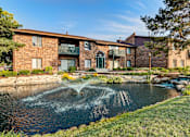 Thumbnail 6 of 28 - A building with a water feature in front.