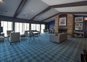 Thumbnail 17 of 31 - A room with a plaid carpet and a stone fireplace.