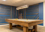Thumbnail 42 of 62 - A pool table with a light hanging above it.