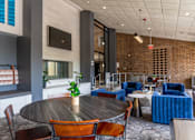 Thumbnail 48 of 62 - A modern dining area with a round table and chairs.