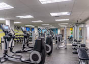 Thumbnail 37 of 62 - A gym with treadmills, exercise bikes, and other equipment.
