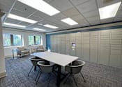 Thumbnail 52 of 62 - A conference room with a long table and chairs.