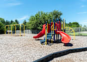 Thumbnail 28 of 62 - A playground with a red slide and yellow safety bars.