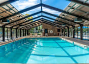 Thumbnail 18 of 62 - A large indoor swimming pool with a glass ceiling.