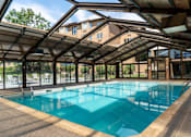 Thumbnail 17 of 62 - A large indoor swimming pool with a glass ceiling.