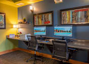 Thumbnail 39 of 43 - Two computer monitors are on a desk in an office.