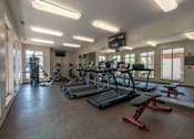 Thumbnail 40 of 43 - A gym with treadmills, exercise bikes, and other equipment.
