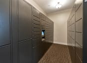 Thumbnail 38 of 43 - A long hallway with a row of lockers on the left and right.