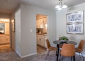 Thumbnail 6 of 43 - A dining room with a table and chairs is shown.