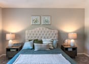 Thumbnail 32 of 43 - A bedroom with a large bed and two lamps.