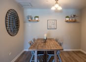Thumbnail 14 of 43 - A dining room with a wooden table and chairs.