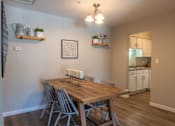 Thumbnail 15 of 43 - A dining room with a wooden table and chairs.
