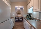 Thumbnail 8 of 43 - A kitchen with a white refrigerator and a round window.