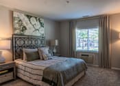 Thumbnail 23 of 43 - A bedroom with a large bed and a painting on the wall.