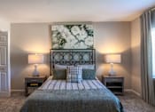 Thumbnail 22 of 43 - A bedroom with a large bed and two lamps.