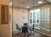 Thumbnail 60 of 73 - A conference room with a glass wall and a sign that says "Conference Room 2".