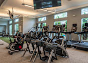 Thumbnail 52 of 73 - A gym with treadmills and exercise bikes.