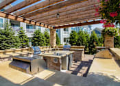 Thumbnail 28 of 73 - A patio with a grill and a table.