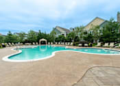 Thumbnail 26 of 73 - A large outdoor swimming pool with a white tile border and a white diving board.