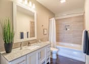 Thumbnail 10 of 73 - A bathroom with a white sink and a large mirror.