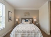 Thumbnail 9 of 73 - A bedroom with a large bed and two lamps.