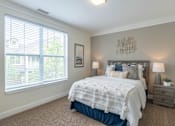 Thumbnail 8 of 73 - A bedroom with a large bed and a window with blinds.