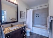 Thumbnail 15 of 73 - A bathroom with a sink, toilet, and bathtub.