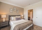 Thumbnail 14 of 73 - A bedroom with a large bed, two lamps, and a carpeted floor.