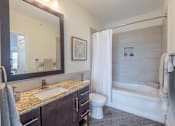 Thumbnail 17 of 73 - A bathroom with a sink, toilet, and bathtub.