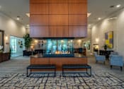 Thumbnail 46 of 73 - A modern living room with a fireplace and a large mirror on the wall.