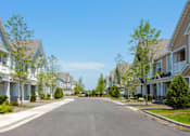 Thumbnail 62 of 73 - A street view of a residential area with houses on both sides.