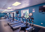 Thumbnail 20 of 25 - A gym with treadmills and exercise equipment.