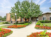 Thumbnail 14 of 25 - A building with a tree in front of it.