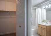 Thumbnail 7 of 25 - A bathroom with a white door and a white sink.