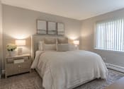 Thumbnail 10 of 25 - A bedroom with a large bed and two lamps.