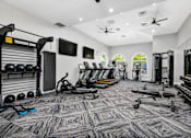 Thumbnail 29 of 53 - A gym with a variety of equipment including weights, treadmills, and exercise machines.