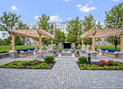 Thumbnail 44 of 53 - A park with a pavement and two wooden pergolas.