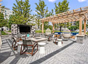 Thumbnail 40 of 53 - A patio with a table, chairs, and a pergola.