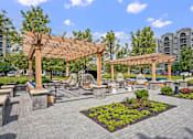 Thumbnail 39 of 53 - A park with a wooden pergola and benches.